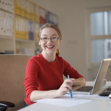 woman in red sweater at office